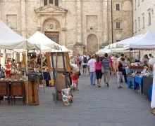 A group of people walking around a market