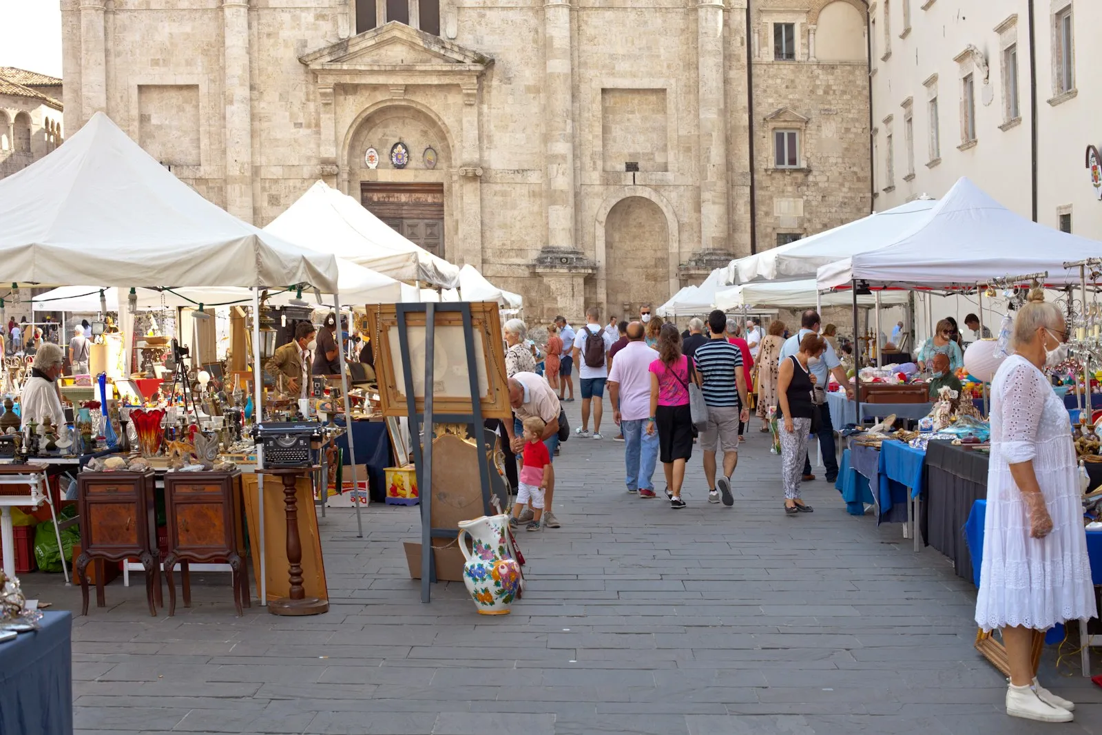 A group of people walking around a market